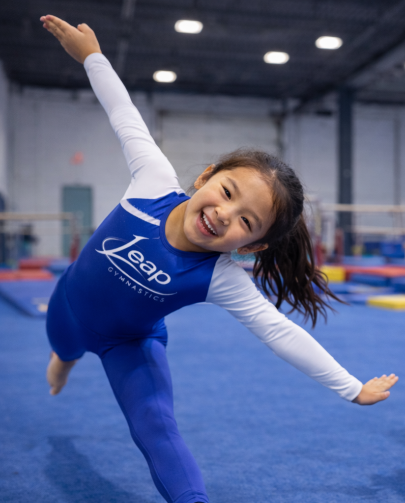 Young gymnast smiling in the Leap facility